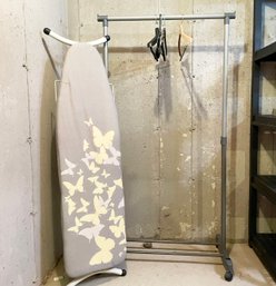 An Ironing Board And Clothes Rack