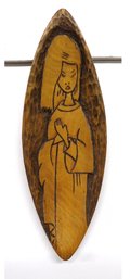 A Carving Of An Asian Woman In Wood.