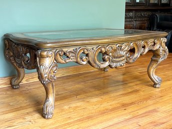 An Ornately Carved Wood Coffee Table With Beveled Glass Top By Schnadig Furniture
