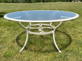 A Cast Aluminum And Tempered Glass Outdoor Dining Table