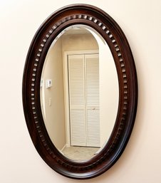 A Beveled Mirror In Carved Mahogany Frame
