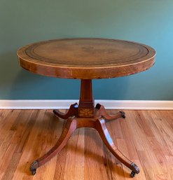 Late 19thC. Tooled Leather Top Marquetry Base Accented And Inlay Leg Round Table On Casters