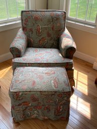 A SLIP COVERED ARMCHAIR AND OTTOMAN