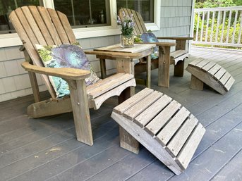A Pair Of Weathered Cedar Adirondack Lounge Chairs And A Cocktail Table