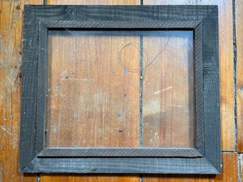 A Large Rustic Wood Frame With Glass