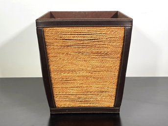 A Woven Fiber And Leather Wastebasket