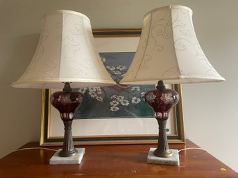 A PAIR OF ETCHED CRANBERRY GLASS OIL LAMPS CONVERTED TO ELECTRIC W/ SILK SHADES