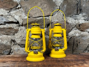 A Pair Of Vintage-Style Metal Railroad Lanterns In Yellow