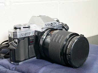 A Vintage Minolta Camera And Soft Case