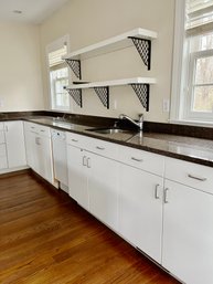 A Group Of White Cabinets And Granite Countertops  - Guest House