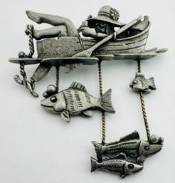 VINTAGE DANECRAFT PEWTER TONE LADY FISHING IN ROWBOAT WITH DANGLING FISH BROOCH