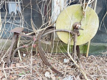 A Large Antique Grindstone On Cast Iron Base