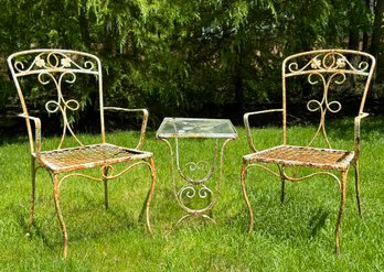 A Pair Of Vintage Wrought Iron Side Chairs And A Glass Top Cocktail Table