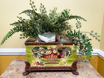 A Hand Painted Footed Cache Pot With Faux Greenery