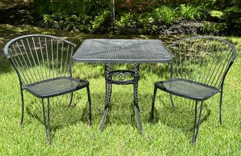 A Wrought Iron Bistro Table And Set Of Two Dining Chairs