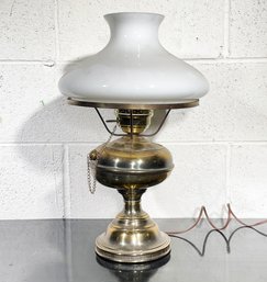 An Antique Brass Hurricane Lamp With Milk Glass Shade - Fitted For Electricity