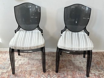 A Pair Of Acrylic Ghost Chairs With Custom Striped Cushions