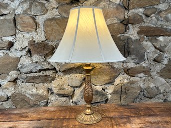 A Beautiful Table Lamp With A Decorative Gold-Toned Metal Body