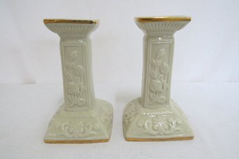 A Pair Of Art Deco Floral Pattern Candlesticks