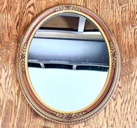 A Carved Wood Framed Oval Mirror