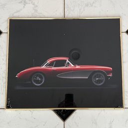 A Framed Photograph Of A Classic Red Corvette