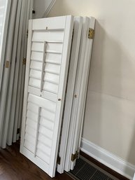 A Set Of 8 Interior Wood Shutters With Gold Hardware