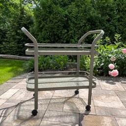 An Outdoor Aluminum Bar Cart With Glass Shelves