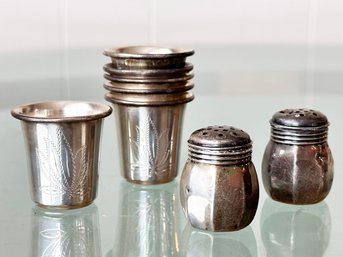 A Group Of Sterling Silver Shot Glasses And Salt Shakers