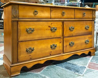 A Solid Wood Dresser With Antique Brass Hardware