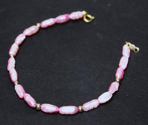 14K Gold Bracelet Having Pink Colored Fresh Water Pearls 7'  Long