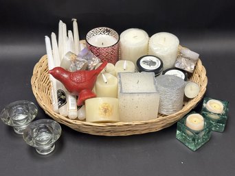 A Great Assortment Of Candles In A Shallow Woven Basket