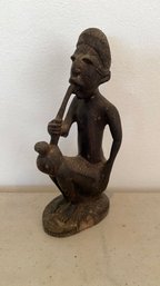 An Antique  African Carved Figure Of A Man Smoking Pipe