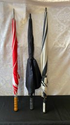 A Group Of Three Used Golf Umbrella