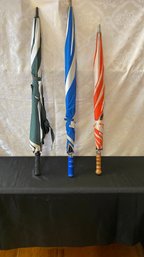 A Group Of Three Used Golf Umbrella