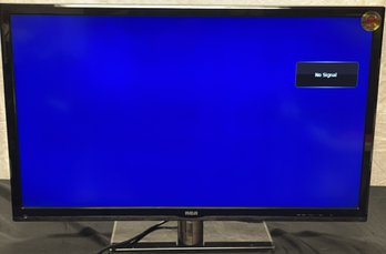 An  RCA 32' LCD Hdtv Dvd Combo Flat Screen Tv With Remote