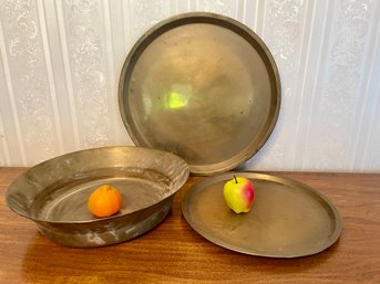 Vintage Brass Lot Of Two Round Trays And One Wide And Low Bowl.