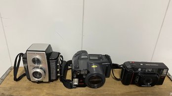 A Group Of Three Cameras