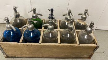 A Vintage Seltzer Bottle Collection With Wooden Crate