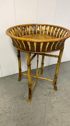 A Round Woven Bamboo Tray Table On Bamboo Stand