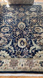A Vintage Hand Knotted Area Rug With Fringe