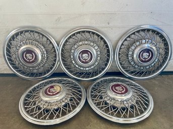 Five Cadillac Wire Spoke Hubcaps .(1)