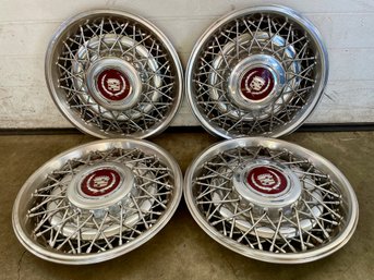 Four Cadillac Wire Spoke Hubcaps . (2)