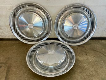 Three  Cadillac Wheels Hubcaps.(5)