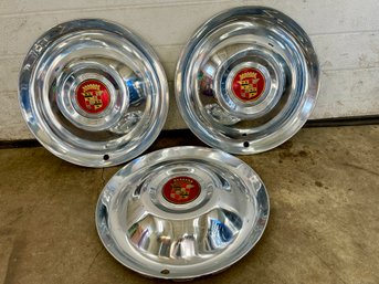 Three Shiny  Cadillac Wheels Hubcaps.(7)