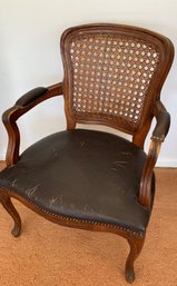 An Antique Cane Back Leather Seat Bergere Chair.