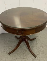 A Vintage Drum Table With Glass Top