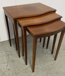 A Set Of Three Stackable Table With Glass Top
