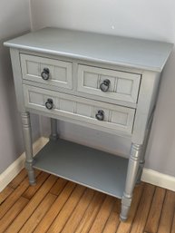 A Painted Side Cabinet With Drawers And Shelf