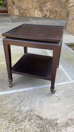 A Baker Furniture Black Small Side Table On Casters.