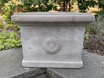 A Cement Planter Box Decorated With Rosettes